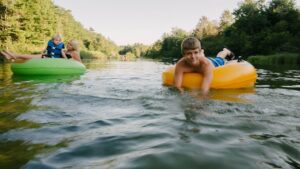 family floating on inflatable tubes on a river