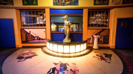 roman-greco art deco at historic latchis hotel, including romanesque statue on a lighted stage, surrounded by motifs above on the wall and below on the floor